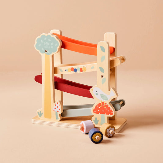 Wooden toy with a slide and colourful design on a beige background