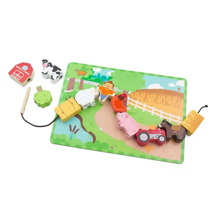 Toy farm lacing game set with animals and a barn on a green play mat
