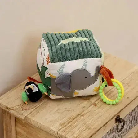 Children's soft toy with elephant design on a wooden surface