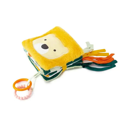 Plush lion toy book with tassels on a white background