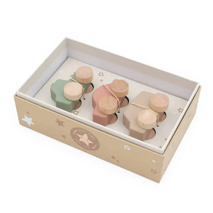 Set of wooden toy cars in a box with a star pattern on a white background