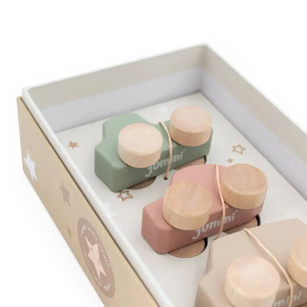 Set of wooden toy cars in a box with 'jumini' branding on a white background