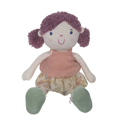 Plush toy doll with purple hair, pink dress, and floral pants on a white background