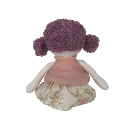 Stuffed doll with purple hair and a floral dress on a white background