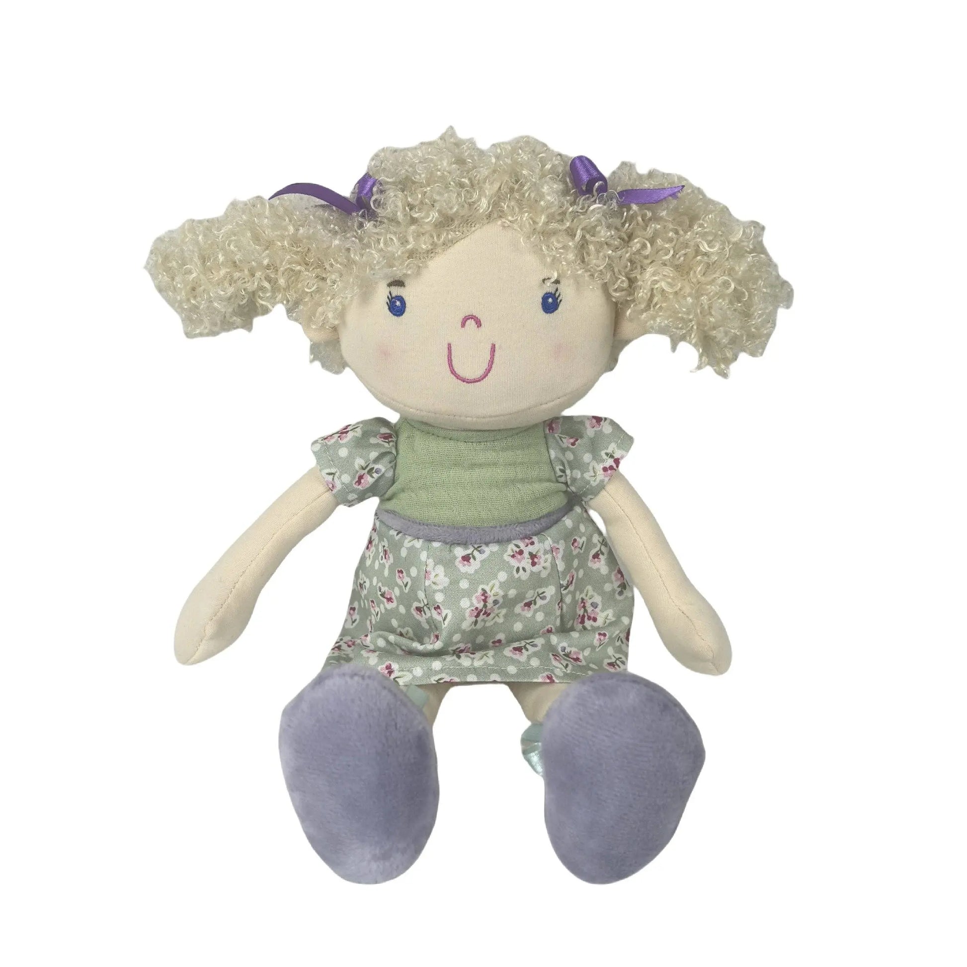 Plush toy doll with blonde hair, floral dress, and purple shoes on a white background