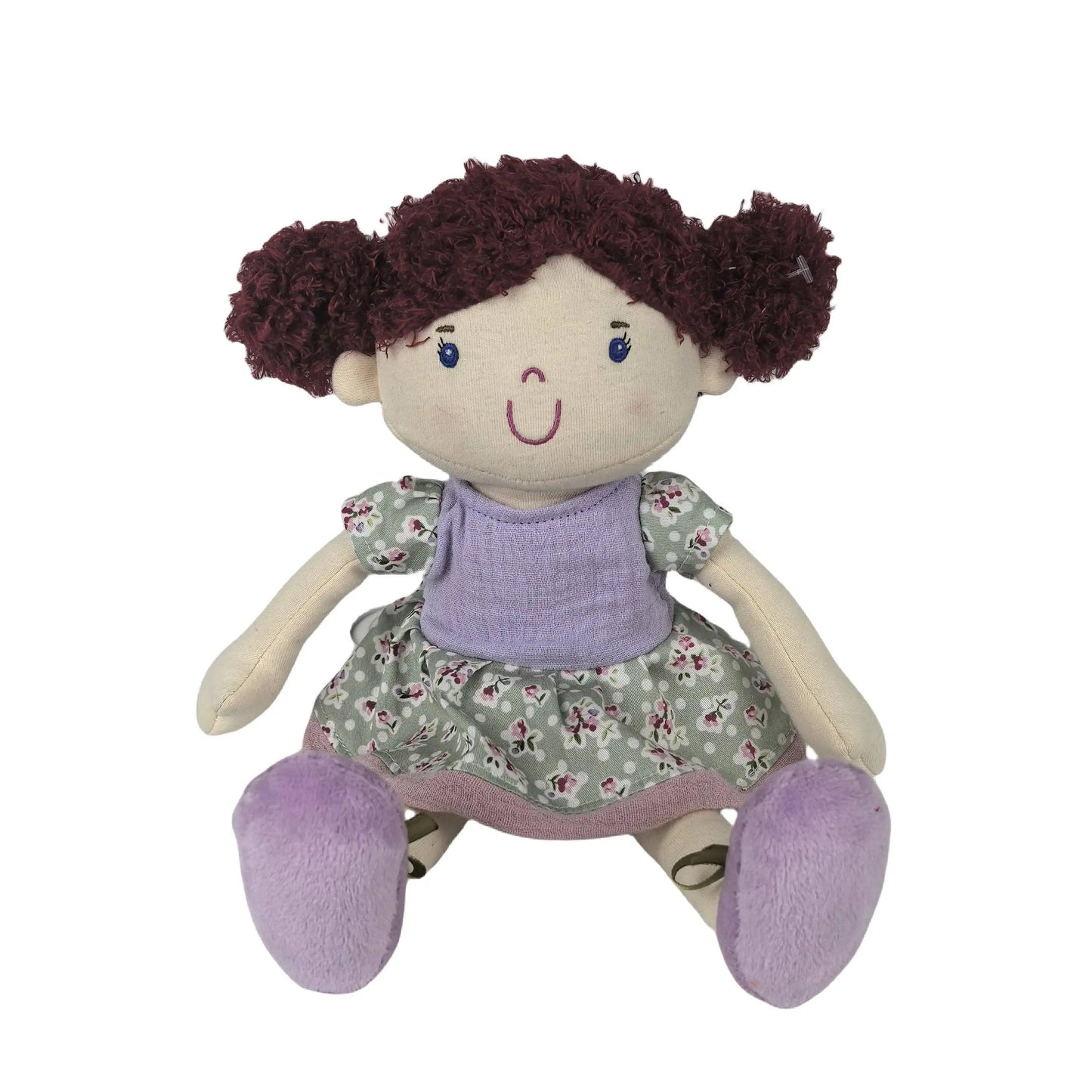 Toy doll with brown hair, purple shoes, and a floral dress on a white background