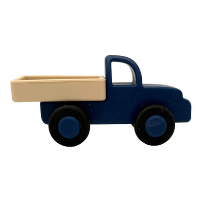 Toy truck with a blue body and beige bed on a white background
