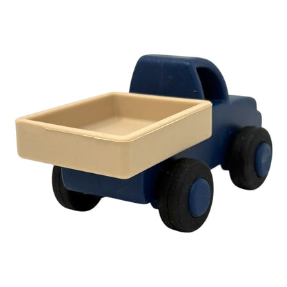 Toy truck with blue body and beige bed on a white background