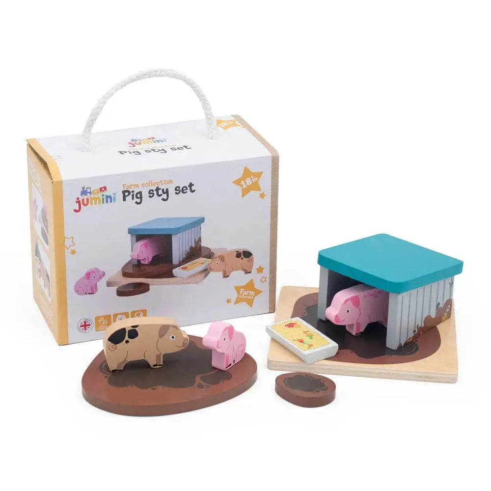 Wooden toy pigsty set with pig figures and packaging on a white background