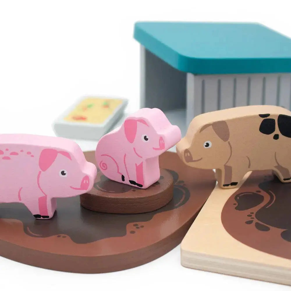 Wooden pig sty set with three pigs on a brown platform, one of which is pink.