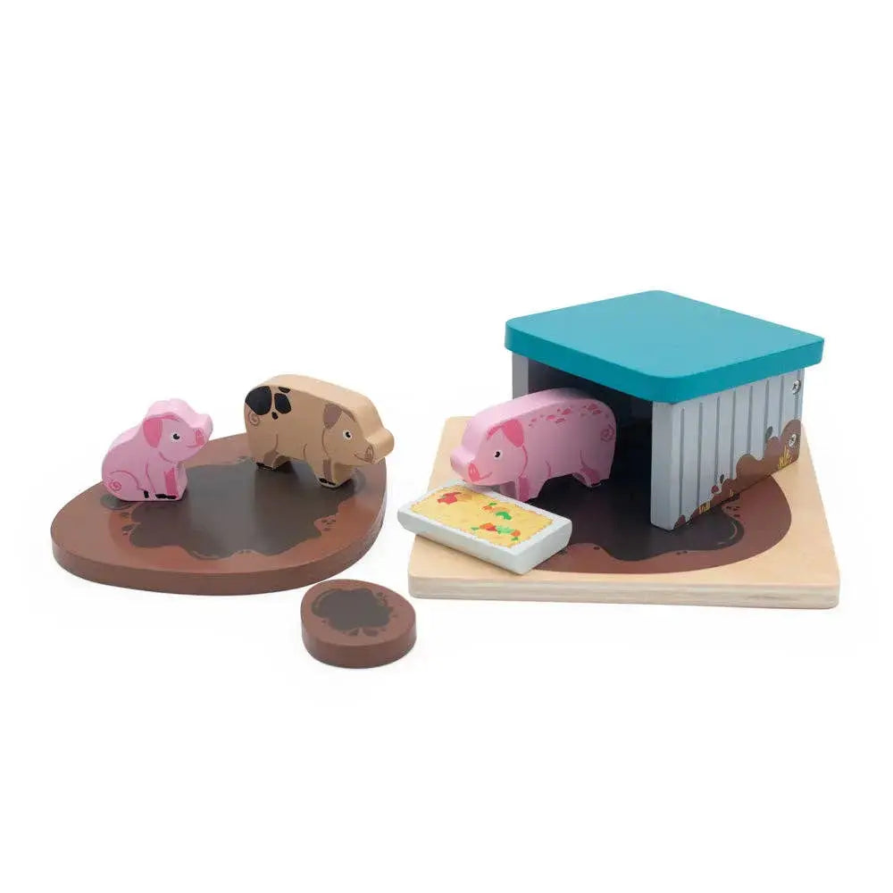 Wooden toy set with pigs and a barn on a white background