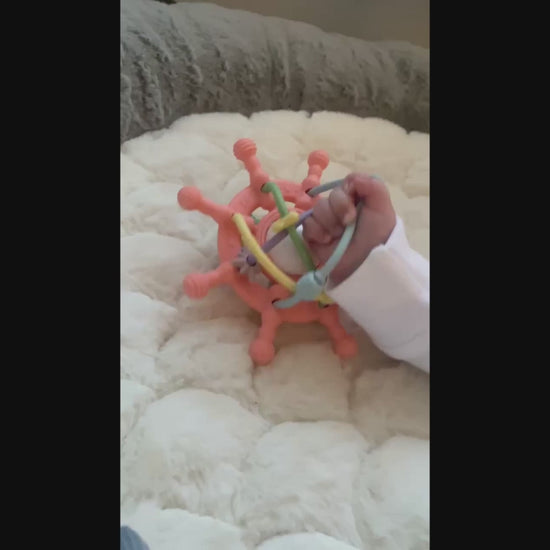 Baby playing with rattle
