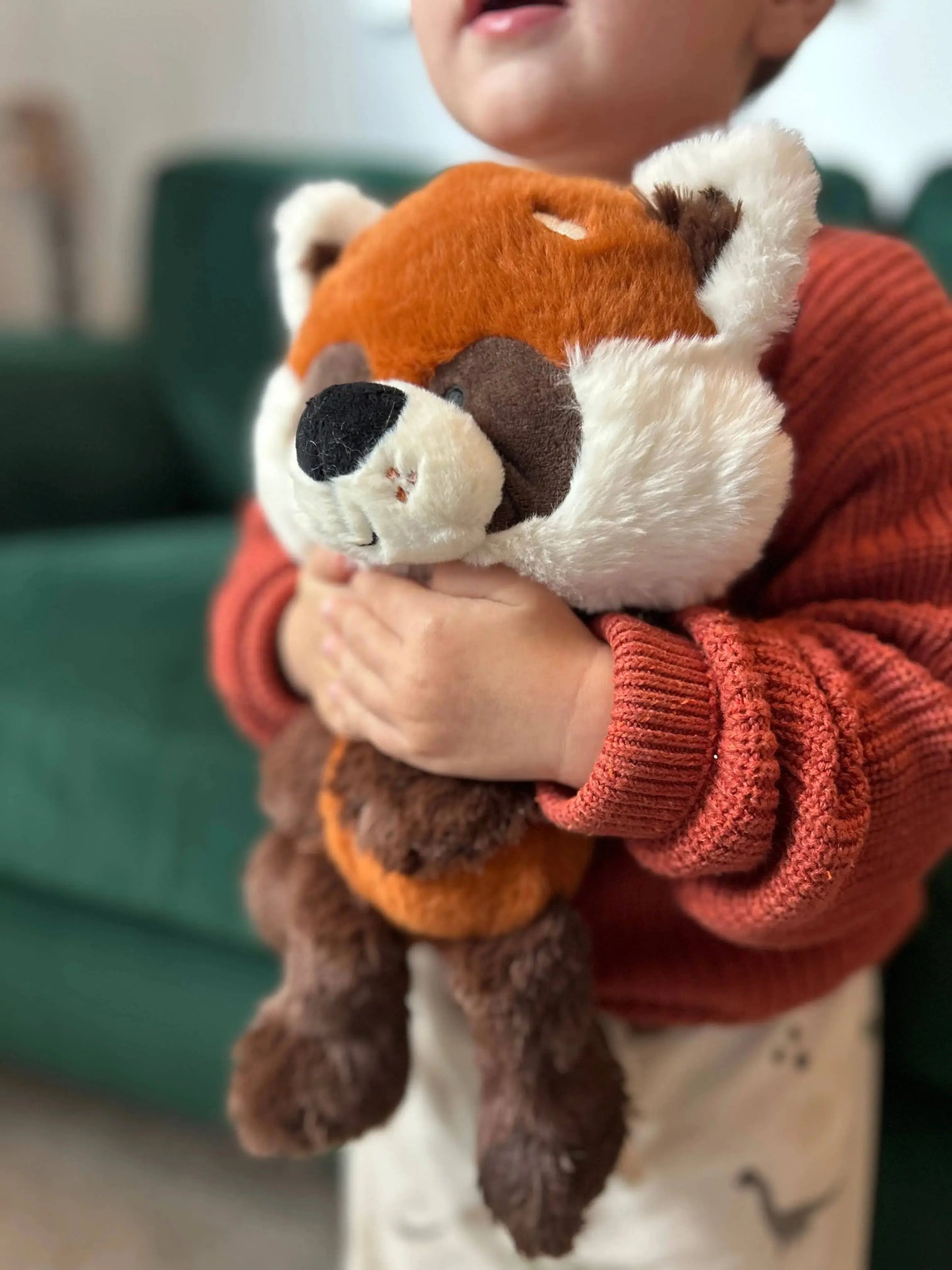 Child holding a plush toy in a cosy indoor setting