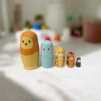 Set of colourful animal-themed nesting dolls on a white surface with a blurred background