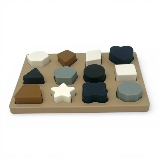 Set of colorful geometric shapes on a silicone base against a white background