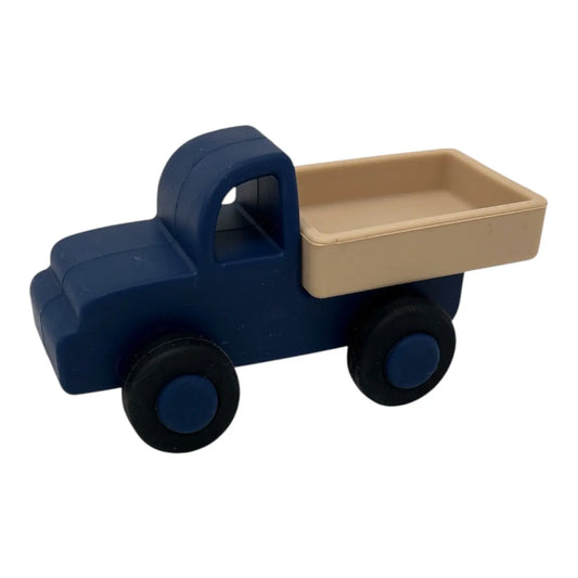 Toy truck with blue body and beige bed on a white background