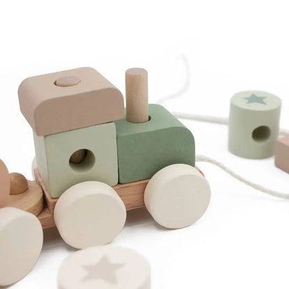 Wooden toy train with colourful blocks on a white background