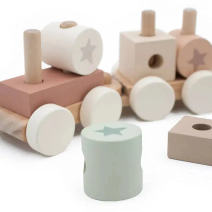 Set of wooden toys with cylindrical blocks and a train-like structure on a white background
