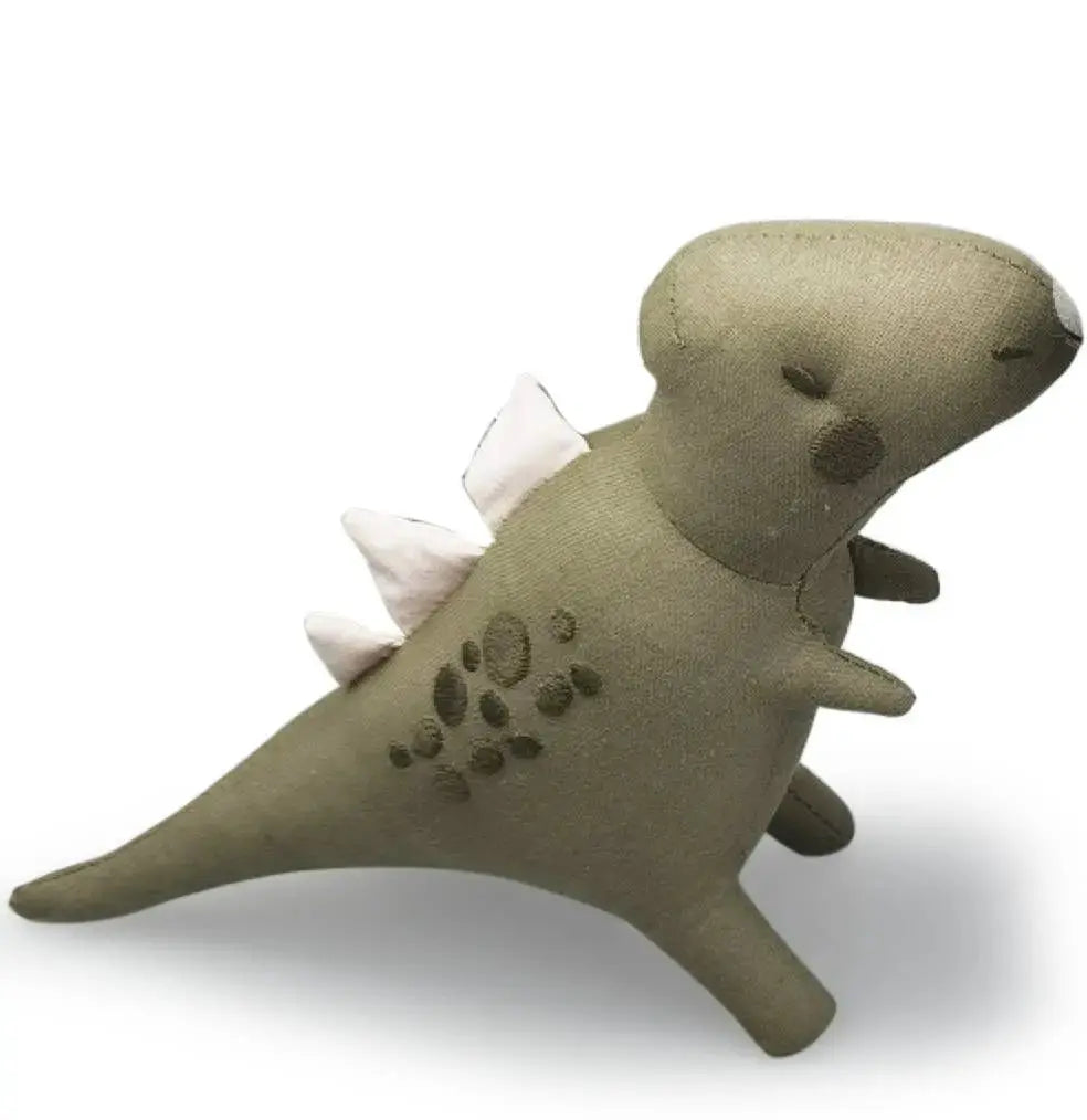 Stuffed toy dinosaur with spikes on a white background