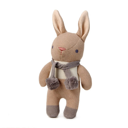 Knitted bunny toy with a scarf on a white background