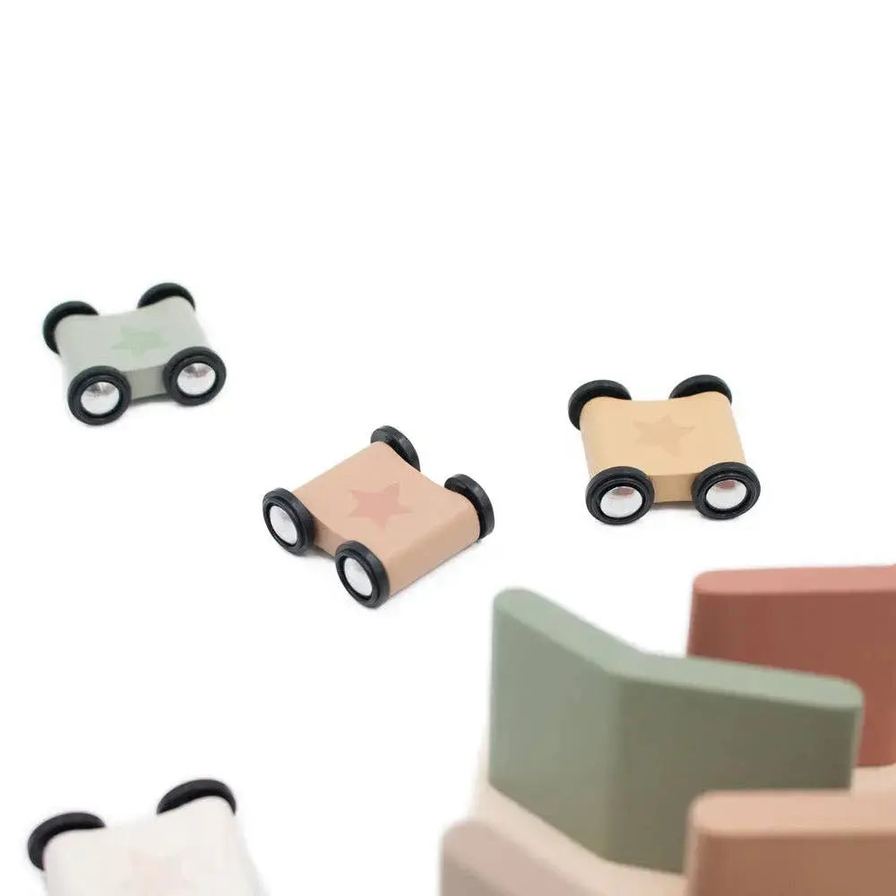 Small wooden cars with wheels on a white background